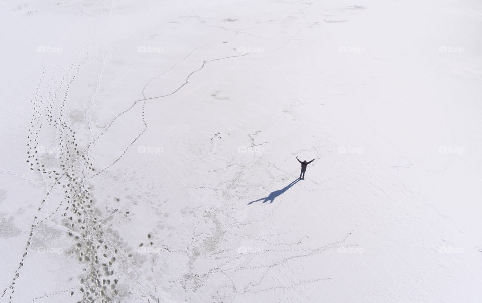 Alone man on the frozen river 