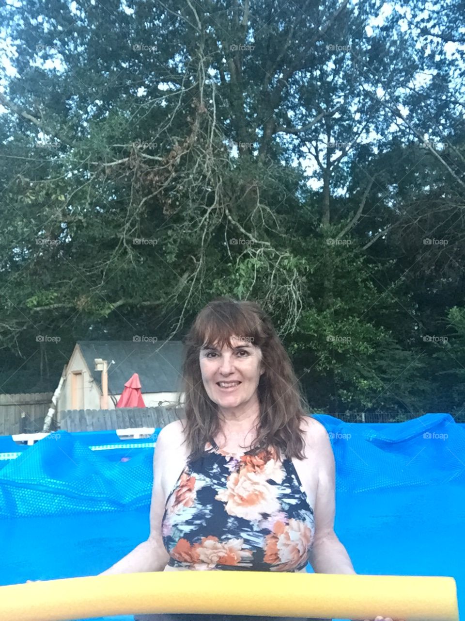 A 67  year old young looking grandmother  in the swimming pool in this month of August 2017 with no work done on her face or body, enjoying the day, and life!