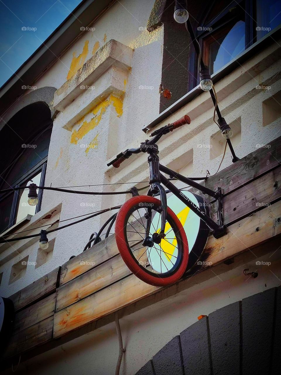 Bicycles. The front of the bicycles: the handlebar and front wheel are attached to a white wall as a decor