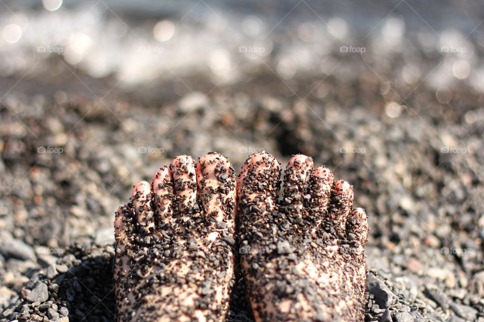 feet in the sand on the beach