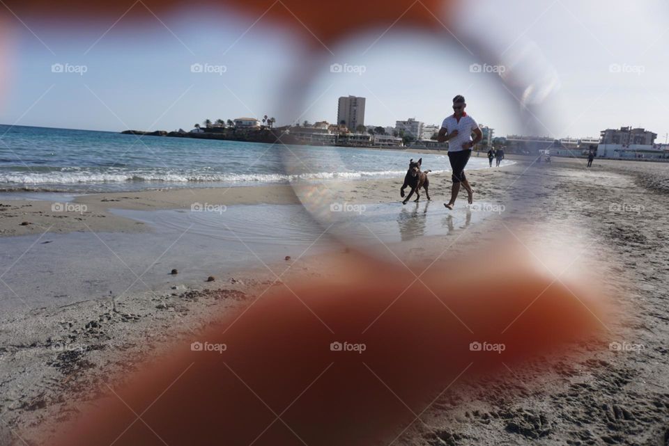 Beach#circles#sea#human#dog#activities#playing