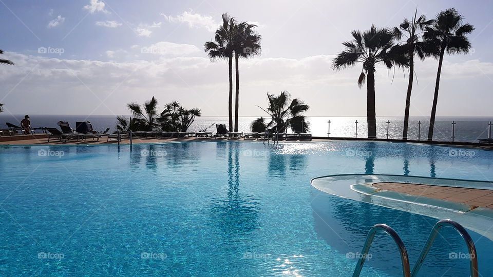 Relaxing by the pool with a view of the ocean 