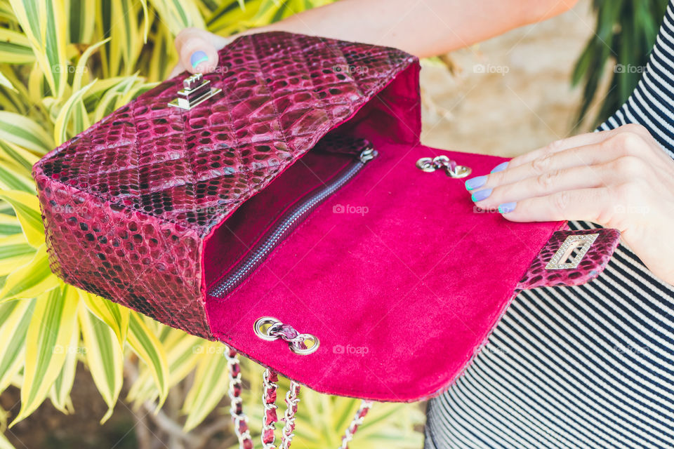 Red python bag in the hands