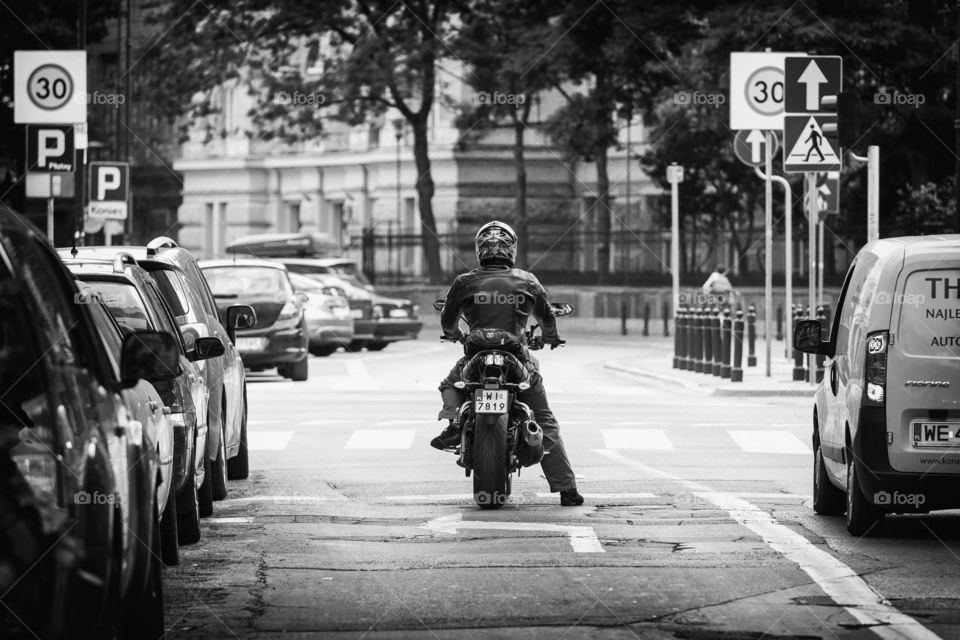 Biker in the city, waiting for green signal on the road