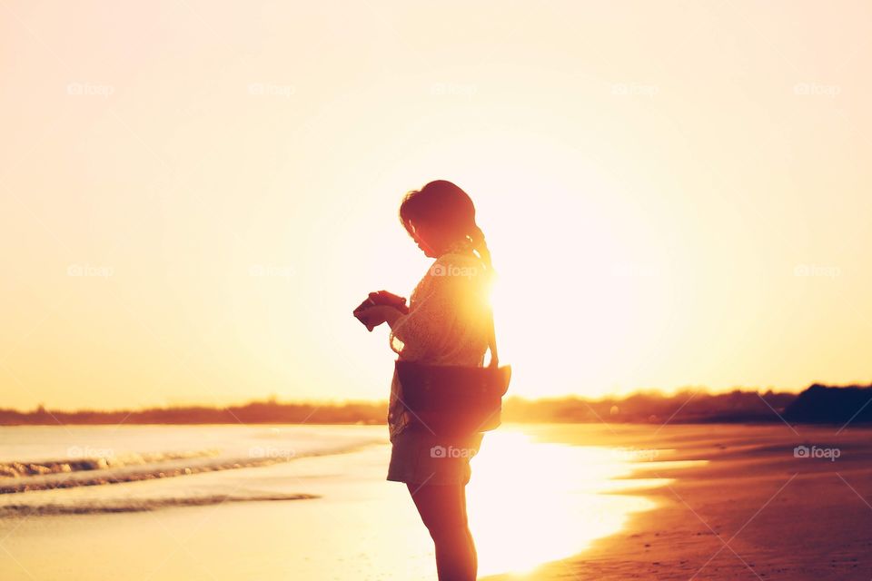 Silhouette of a girl by the seashore.
