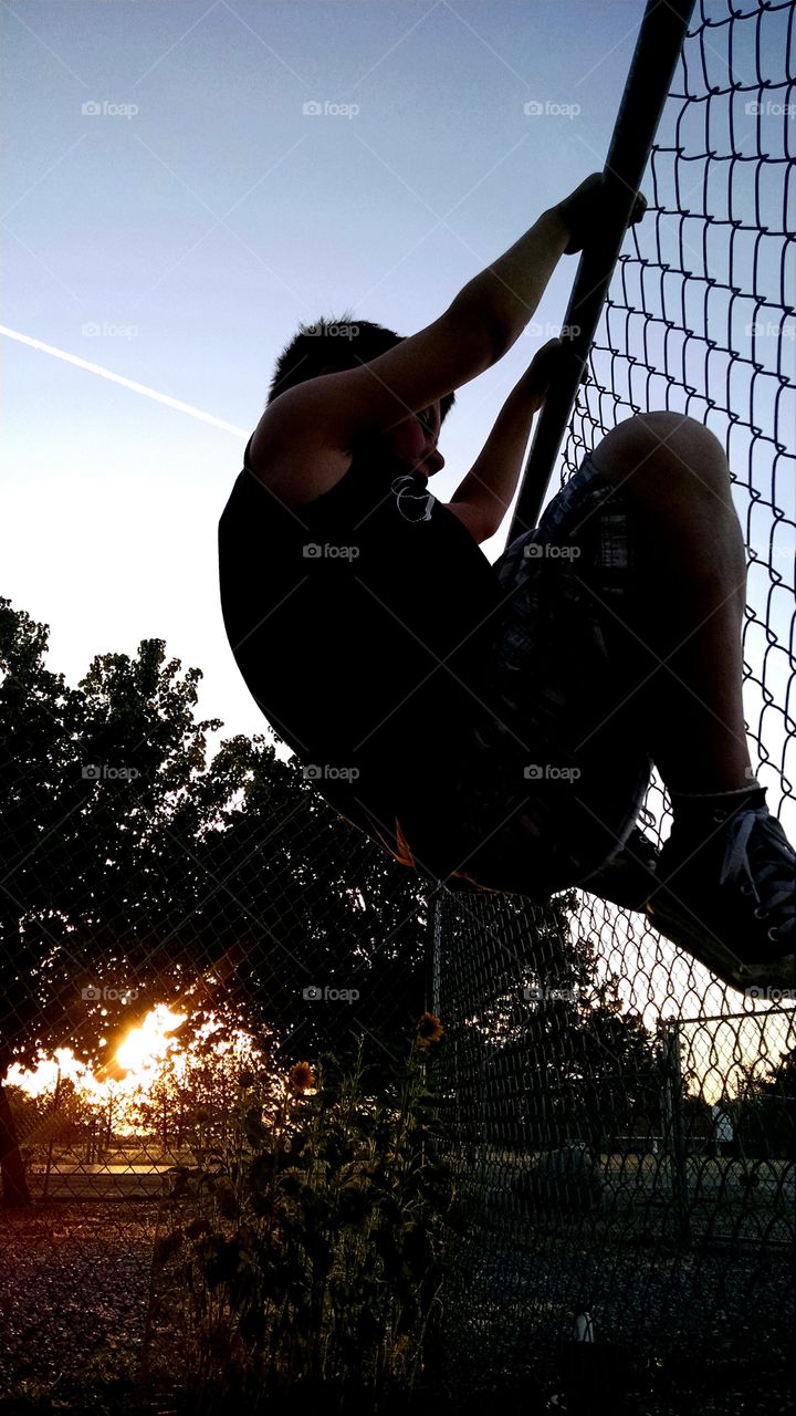 climbing. climbing the fence