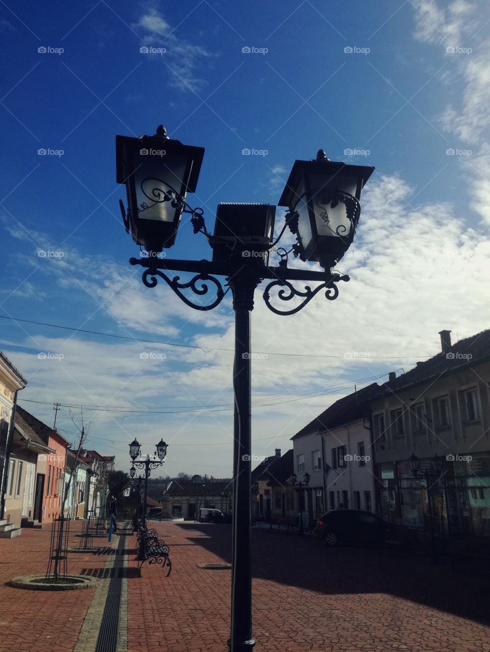 street lamp, city and blue sky with clouds
