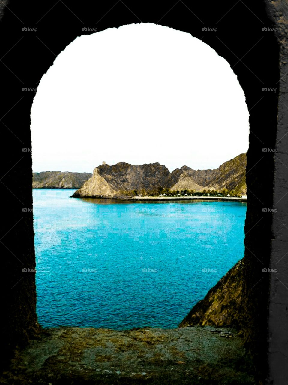 Old castle window overlooking the sea and mountains