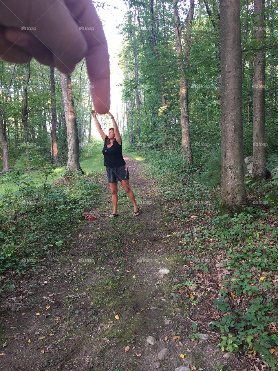 Walking through the woods with my daughter trying to create a scene to look like i was trying to grasp her finger. 