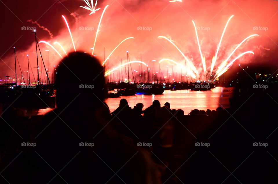 Image showing a human silhouette in front of a huge firework called Seenachtsfest in Konstanz. Red color explosion.
