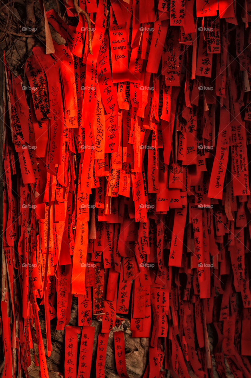 Names on lucky red papers in Chinese temple "San Jao Phaw Khao Yai", Ko Sichang, Thailand.