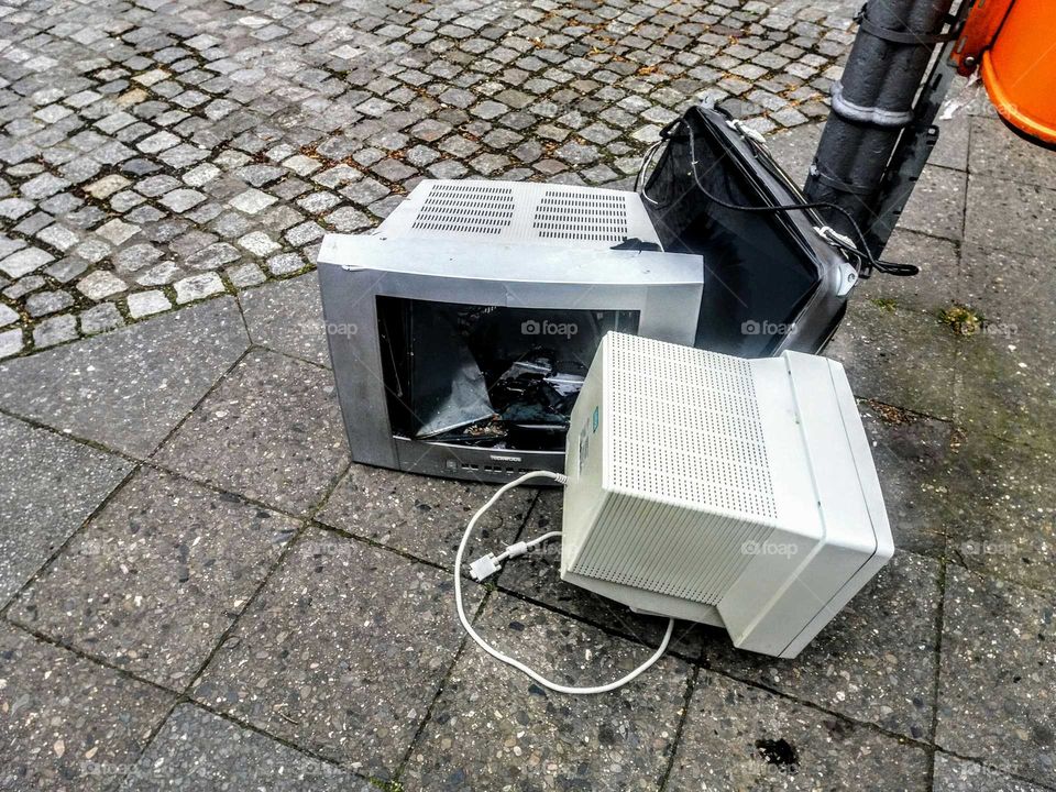 old computer screens  lying on street