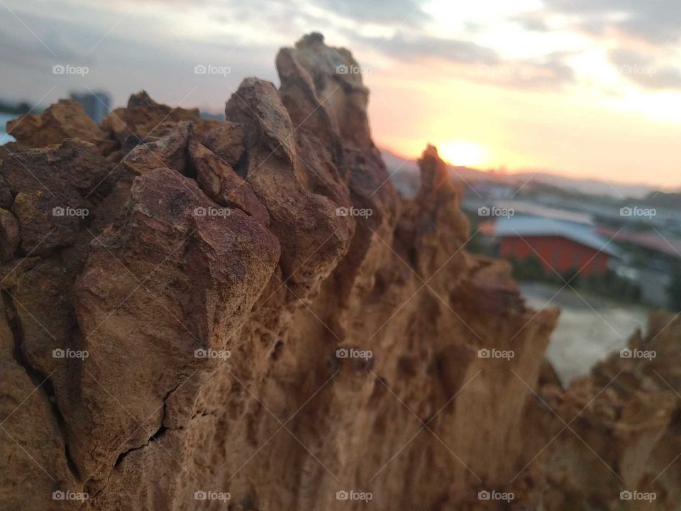 A beautiful view of sun set behind the stuning rock.