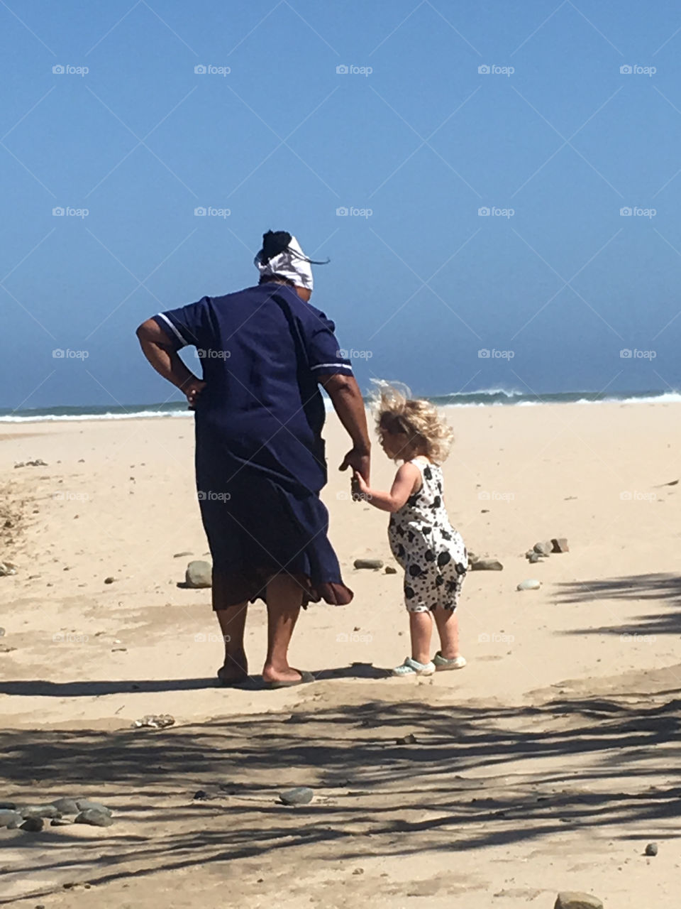 Nanny and child on the beach
