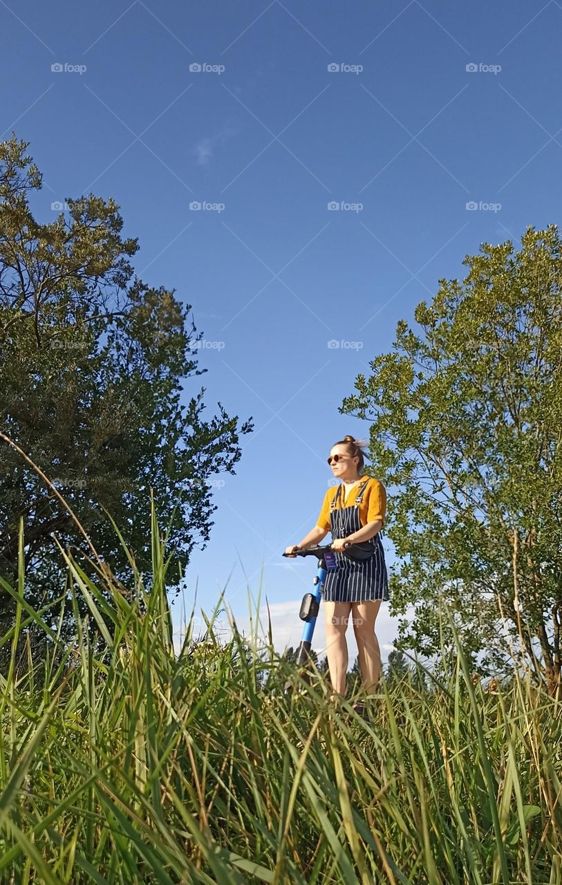 girl on a electric scooter, summer time