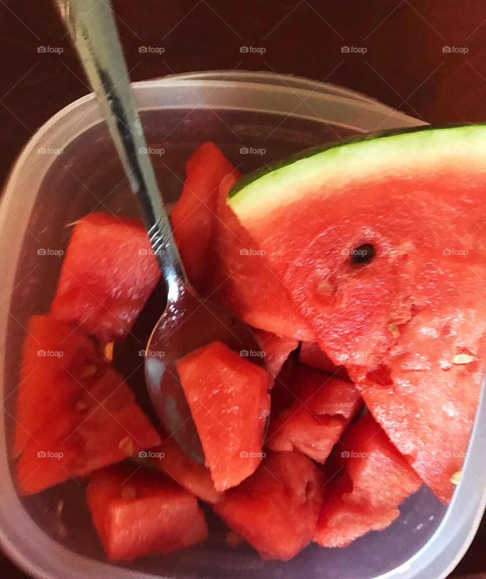 Juicy watermelon red and delicious with a serving spoon ready to be eaten 