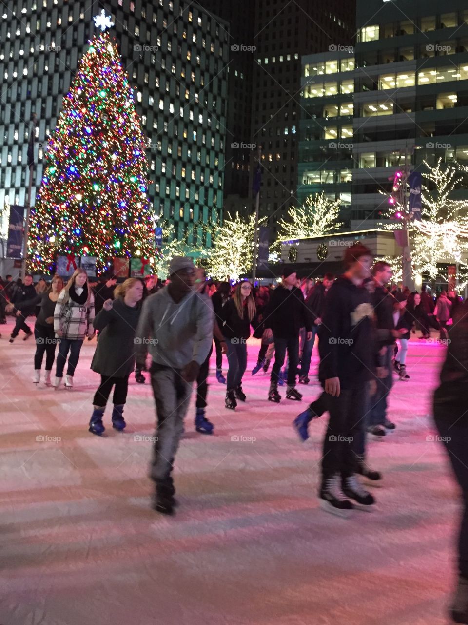 People on street near illuminated christmas tree during winter