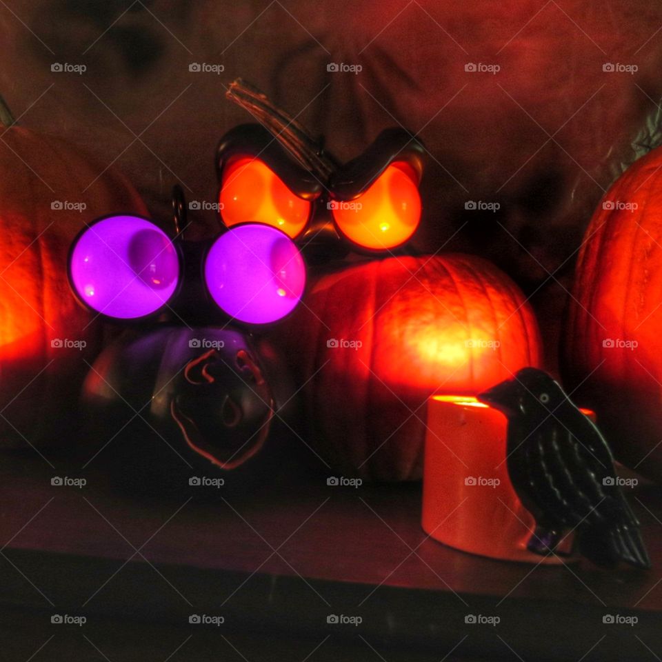 Spooky Halloween shot with pumpkins, candles and popping eyes.