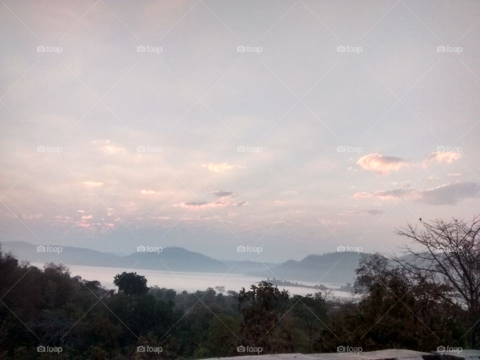 sunrise early morning 7:15@m .mobile capture. nature allows amazing in earth. mountain with river and forest sky all very beautiful in pic.