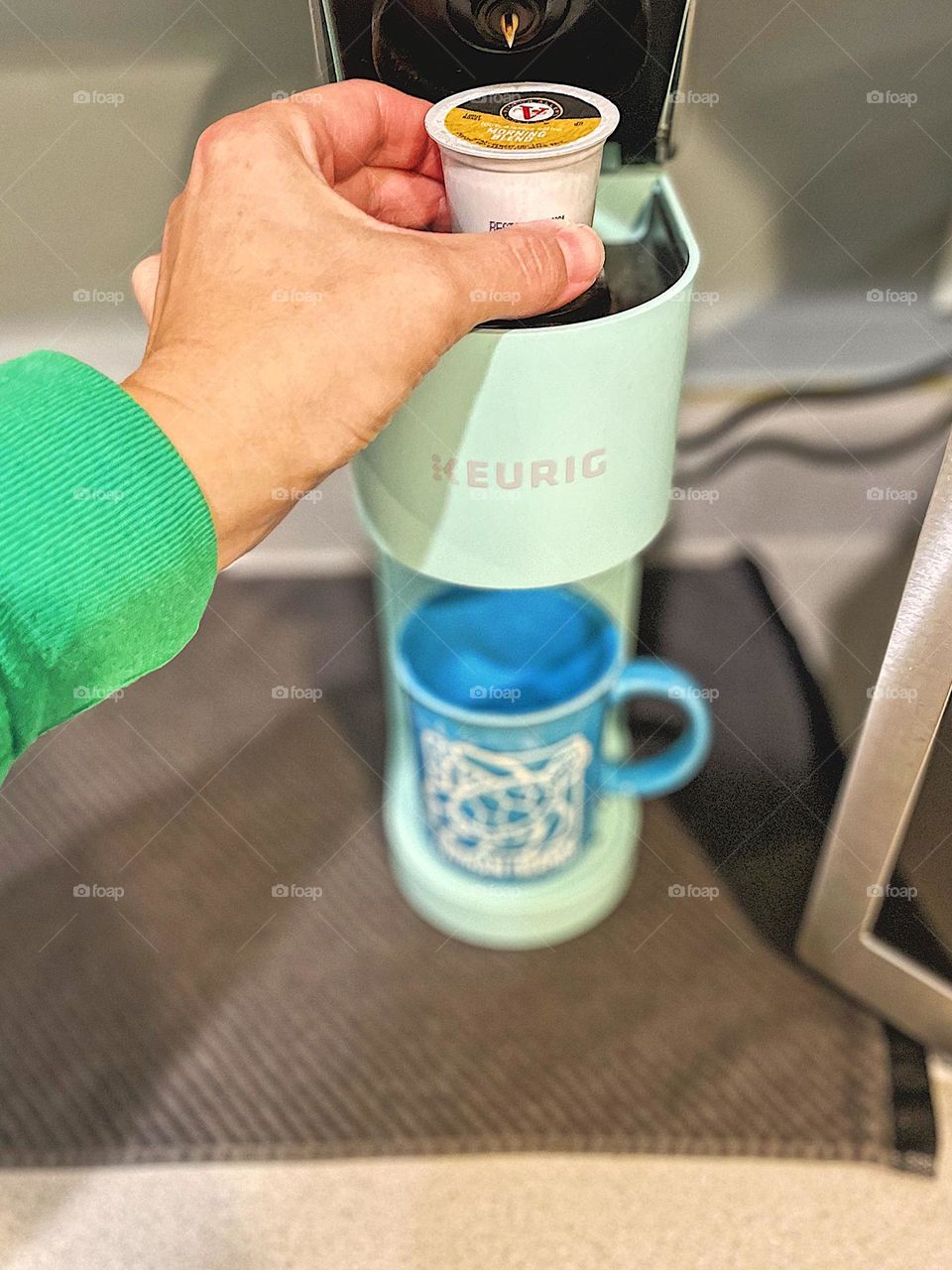 Making coffee, woman’s hand making keurig coffee, hand putting coffee pod in coffee maker, making coffee in a keurig, hand using a keurig coffee maker, daily morning routines