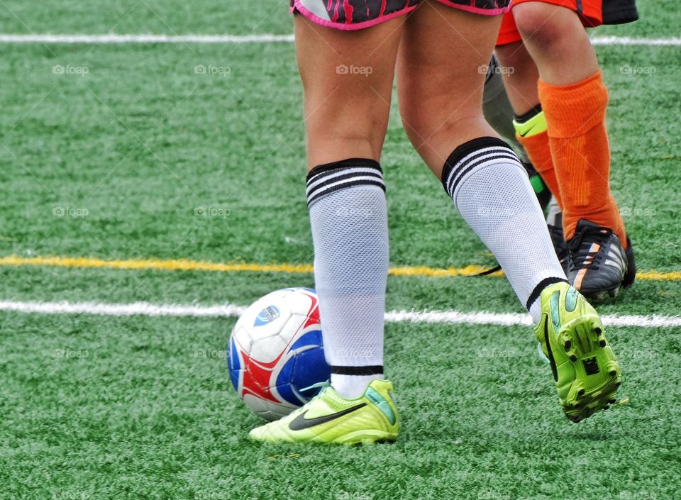 Kicking A Soccer Ball. Feet On The Soccer Pitch