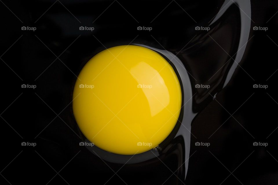 Yolk on black background.  top view,  close up