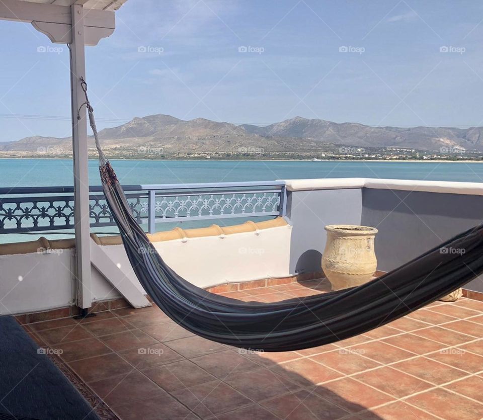 Chilling out in the hammock on the rooftop with views of mainland Greece 