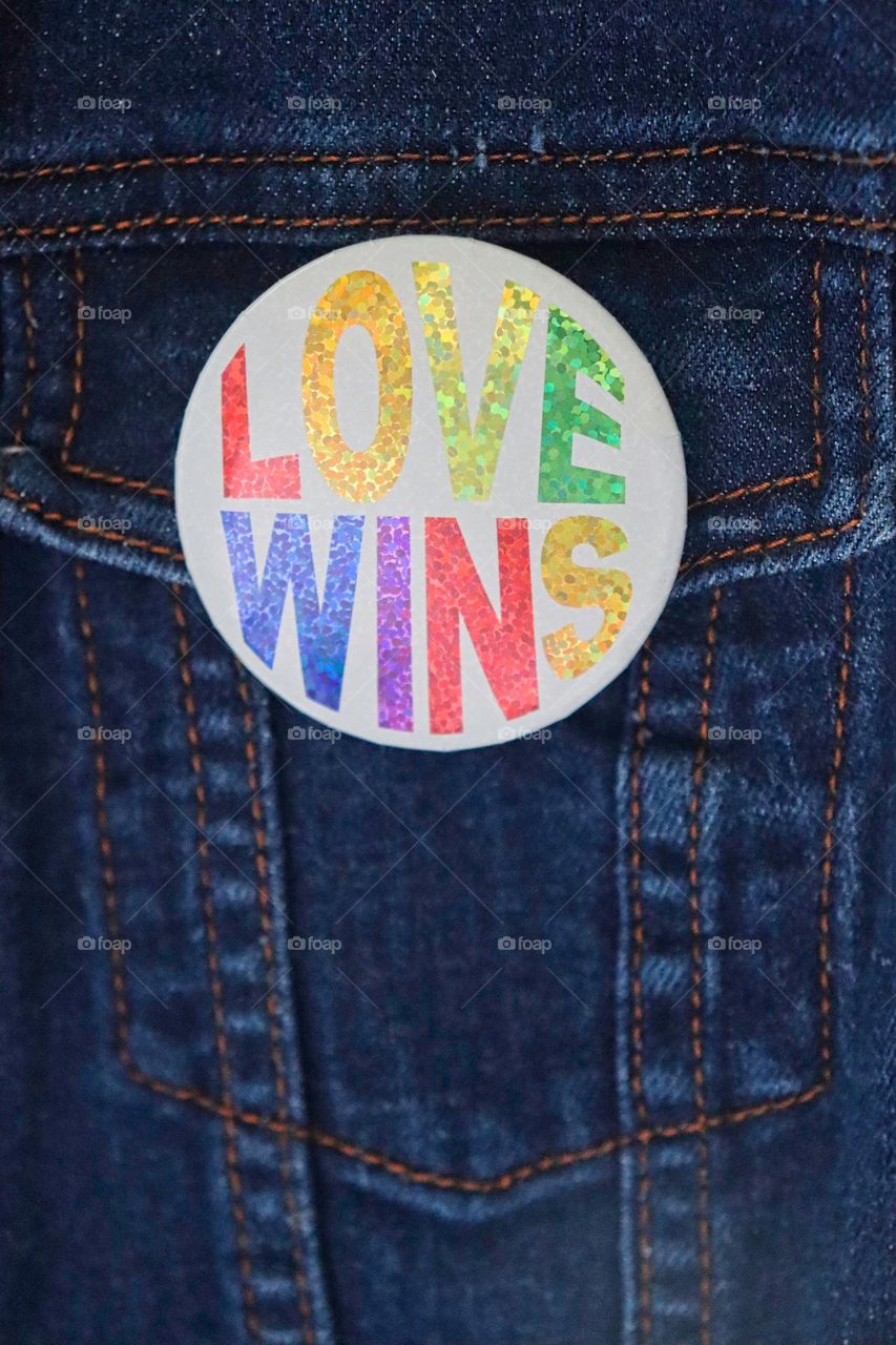 Love wins pin on denim jacket 