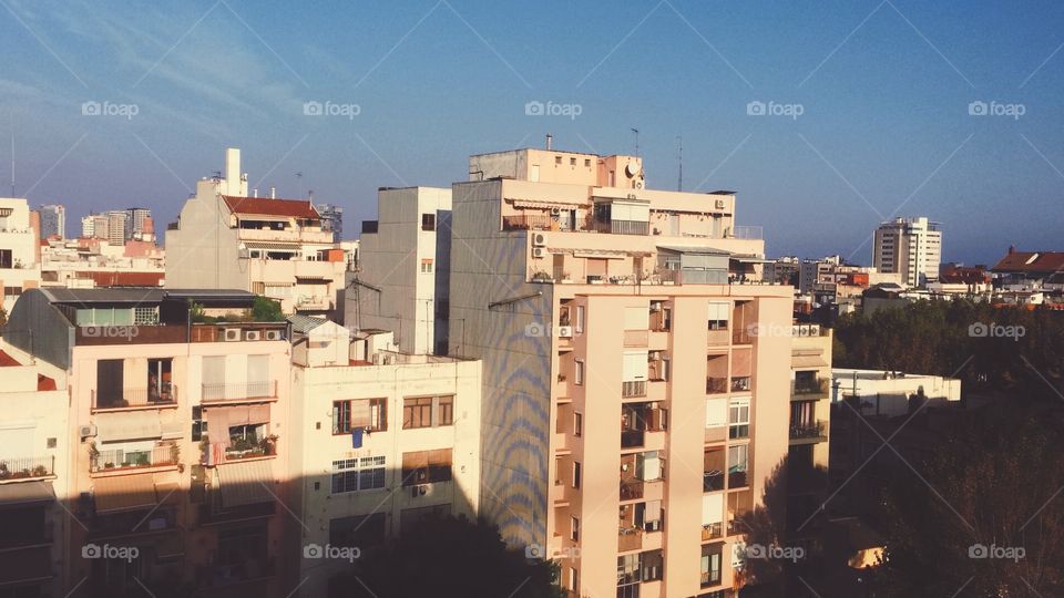 Cityscape view of buildings in El Poblenou Barcelona Spain at sunset from a hotel room window 
