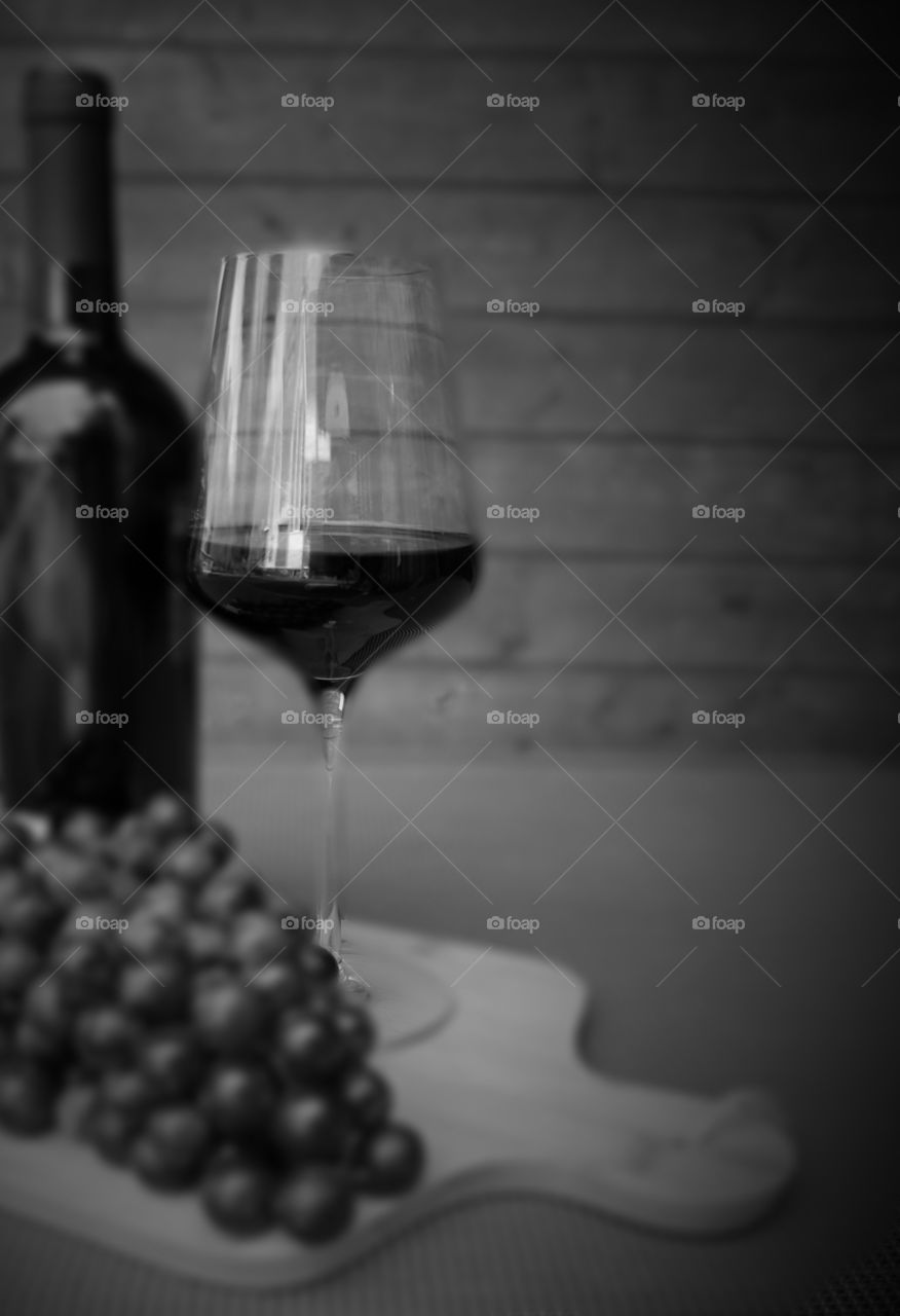 Red wine with grapes. Red wine glass and bottle with grapes