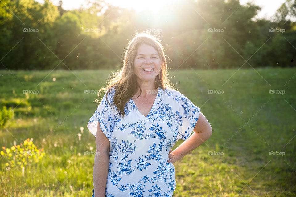 Smiling woman in a field on a sunny day