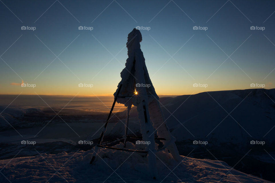 Sunset through triangular pillar