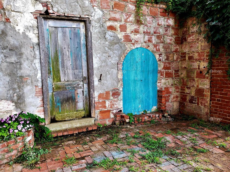 Weathered doors and bricks form an interesting contrast