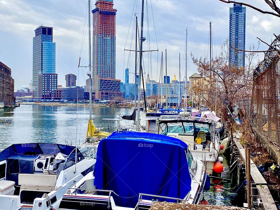 The Newtown Creek “harbor area” with multiple different kinds of boats in Long Island City, Queens, NY was photographed just today on December 27th, 2021 underneath a slightly overcast sky. Hypnotic Productions
