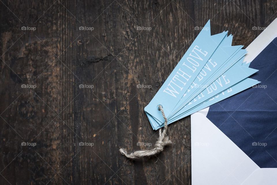 white envelope on wooden background with love tag