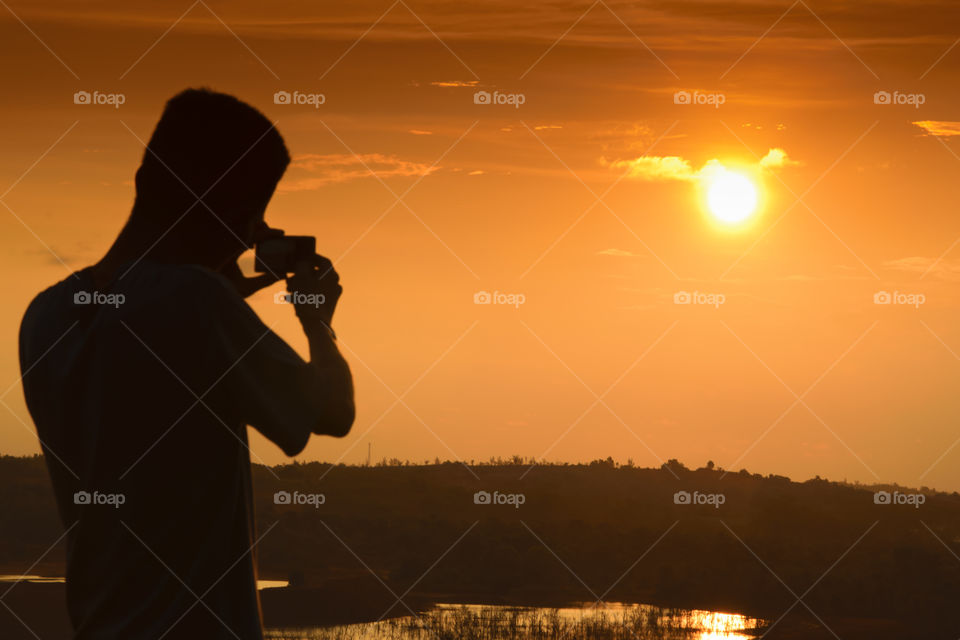 Photographer Taking pictures of sunset