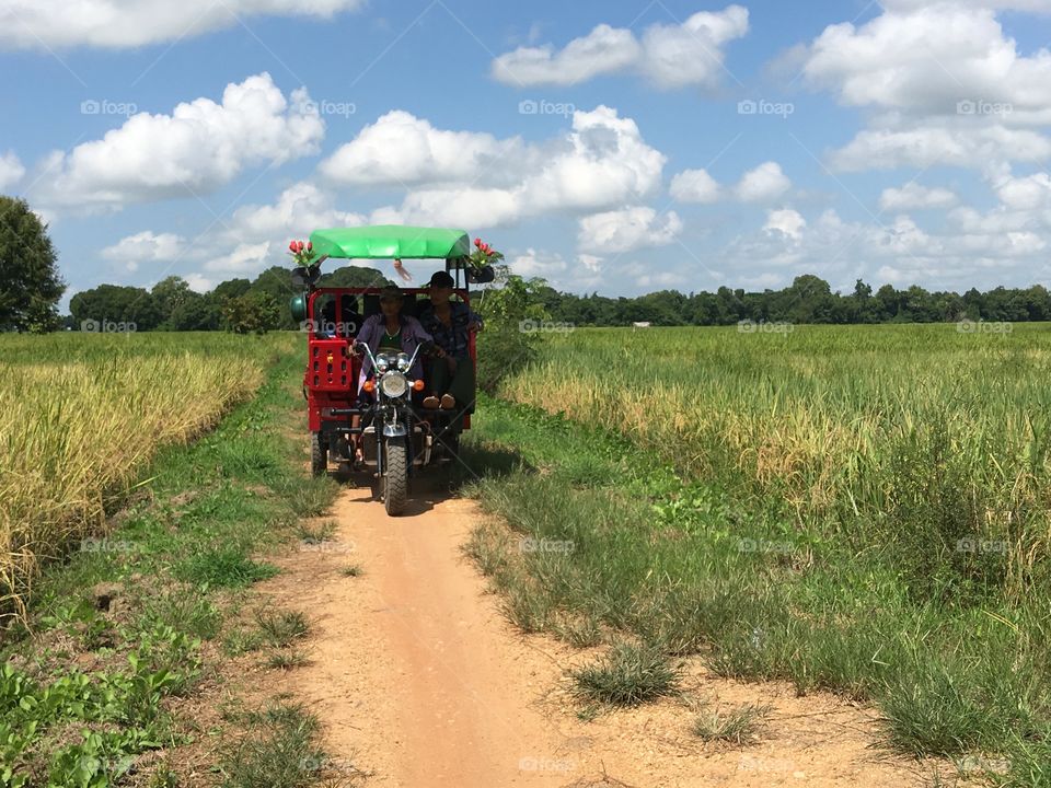 The road to enter village with motorcycle carrier 