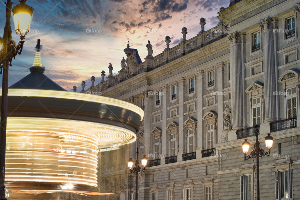 Long exposure of a carousel in front of the royal palace during sunset