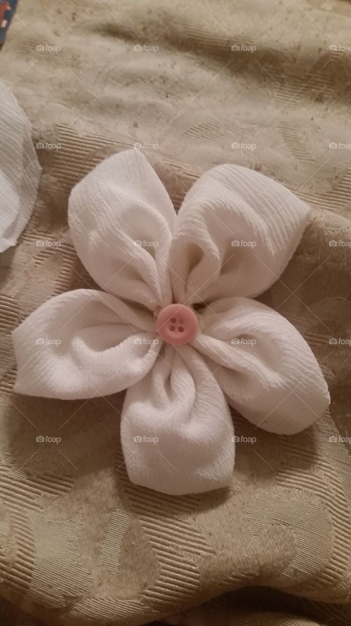 sewing a flower. first attempt at making a flower with material.
