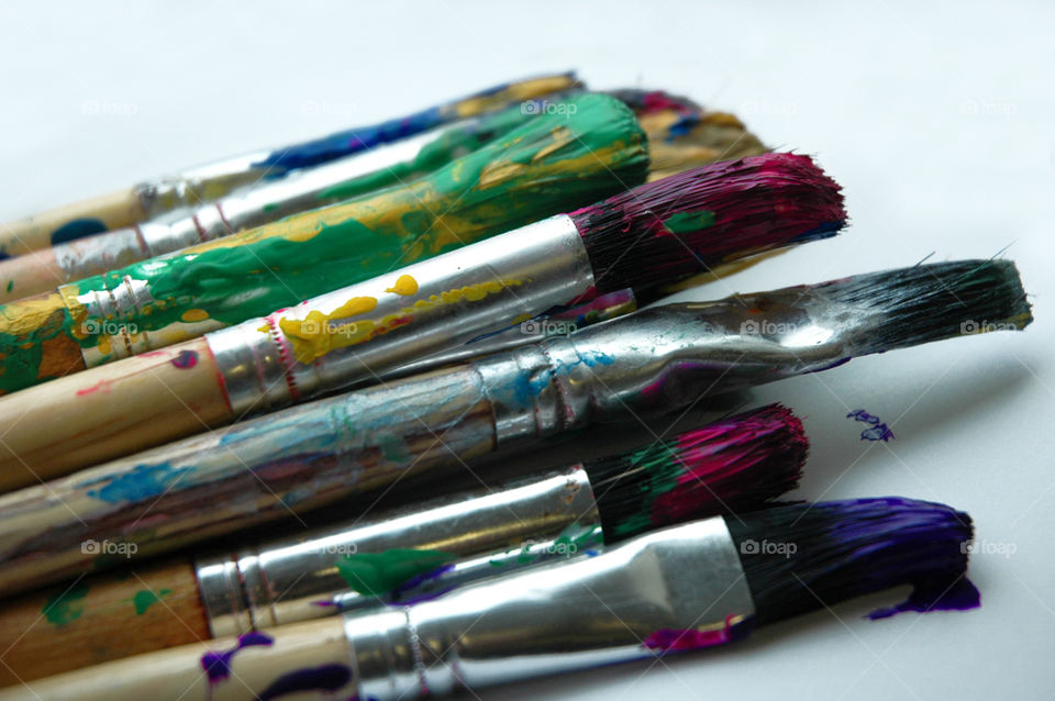 Art brushes covered in colored paint