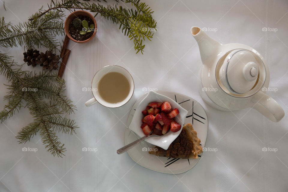 Tea, strawberries and pecan pie in a festive flat lay