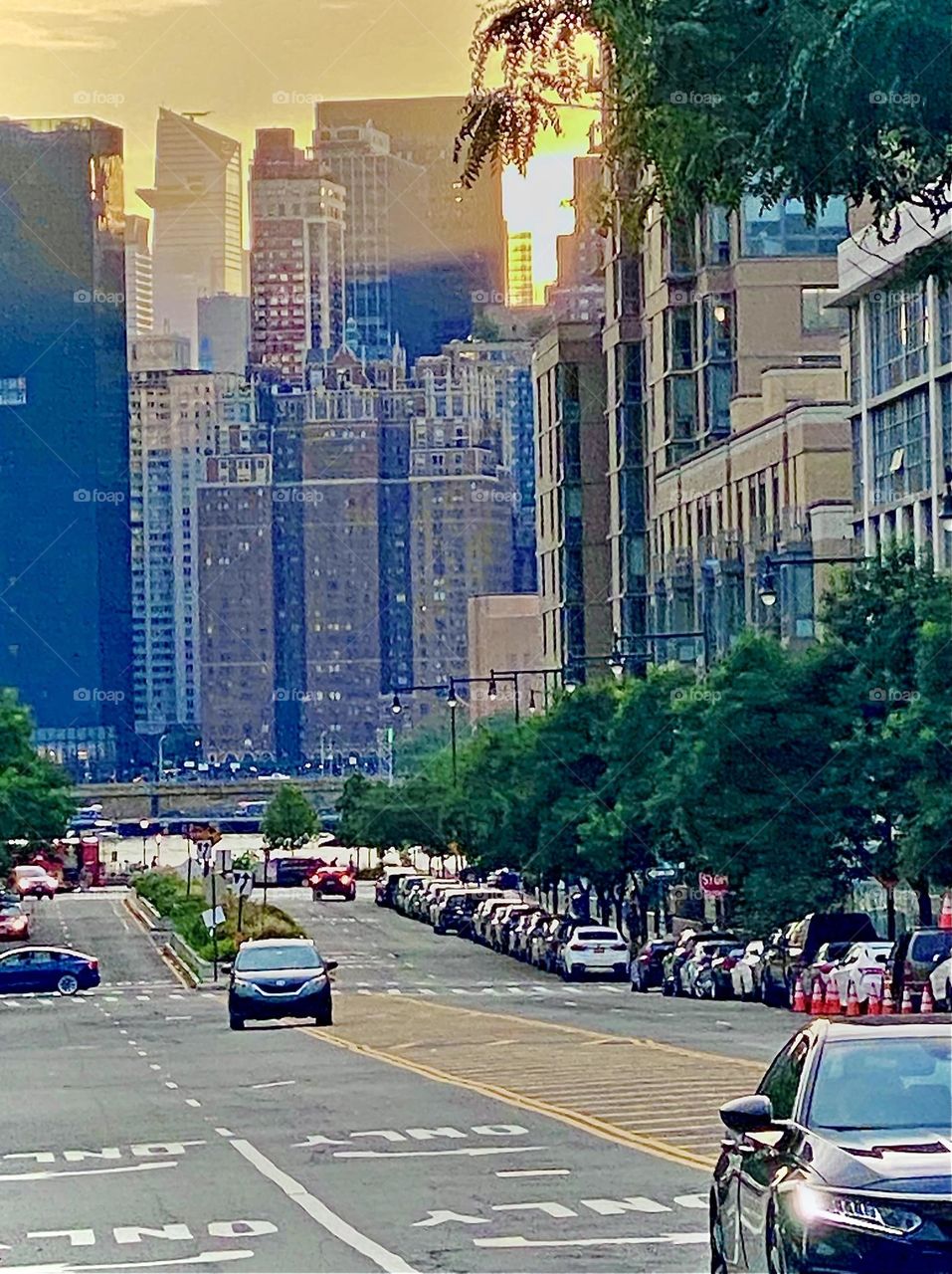 An interesting big city panorama from “Long Island City”, Queens, NY with multiple very tall buildings and rush hour traffic beginning to roll in. 2022. Hypnotic Productions