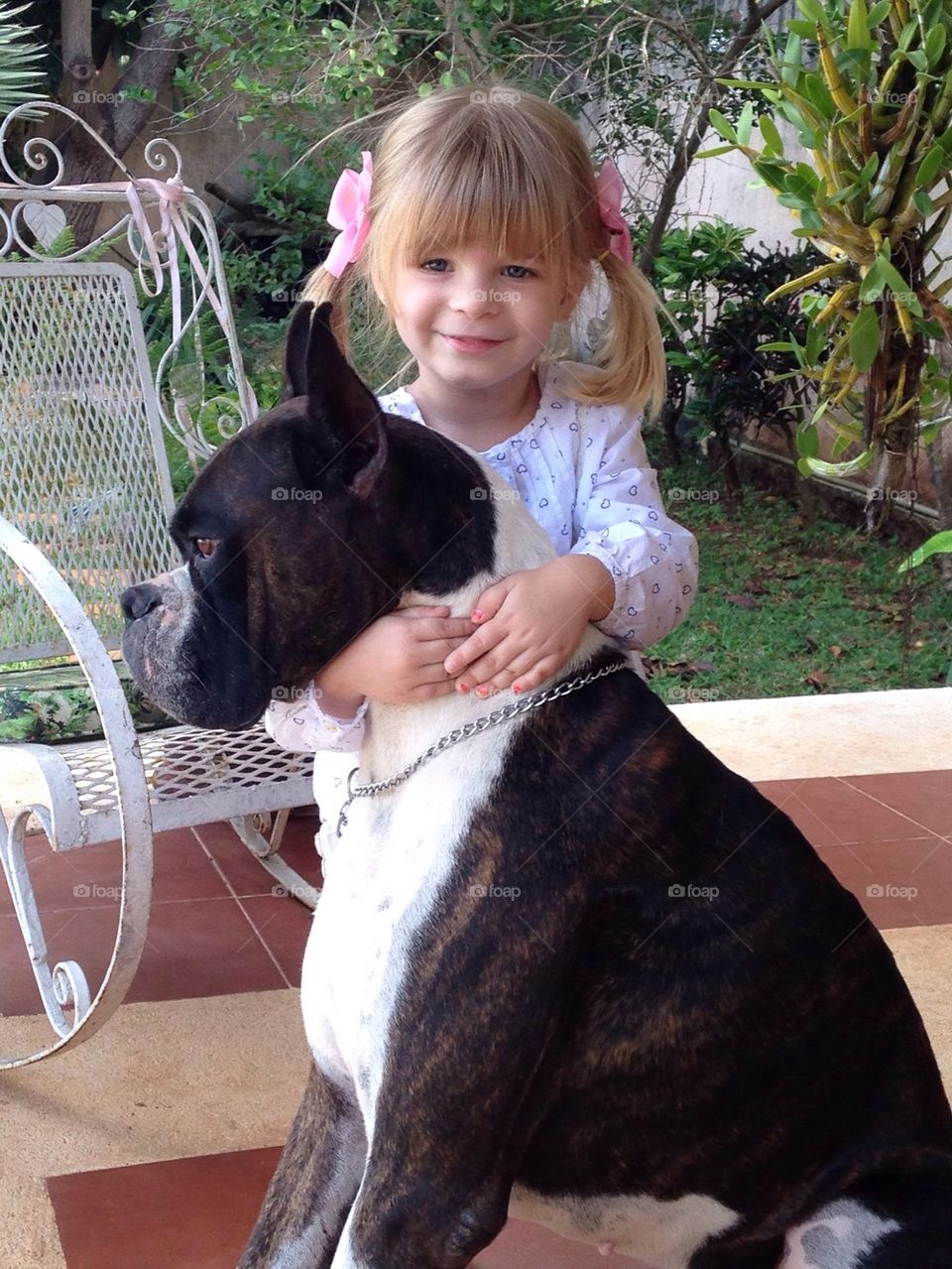 Little girl hugging her dog