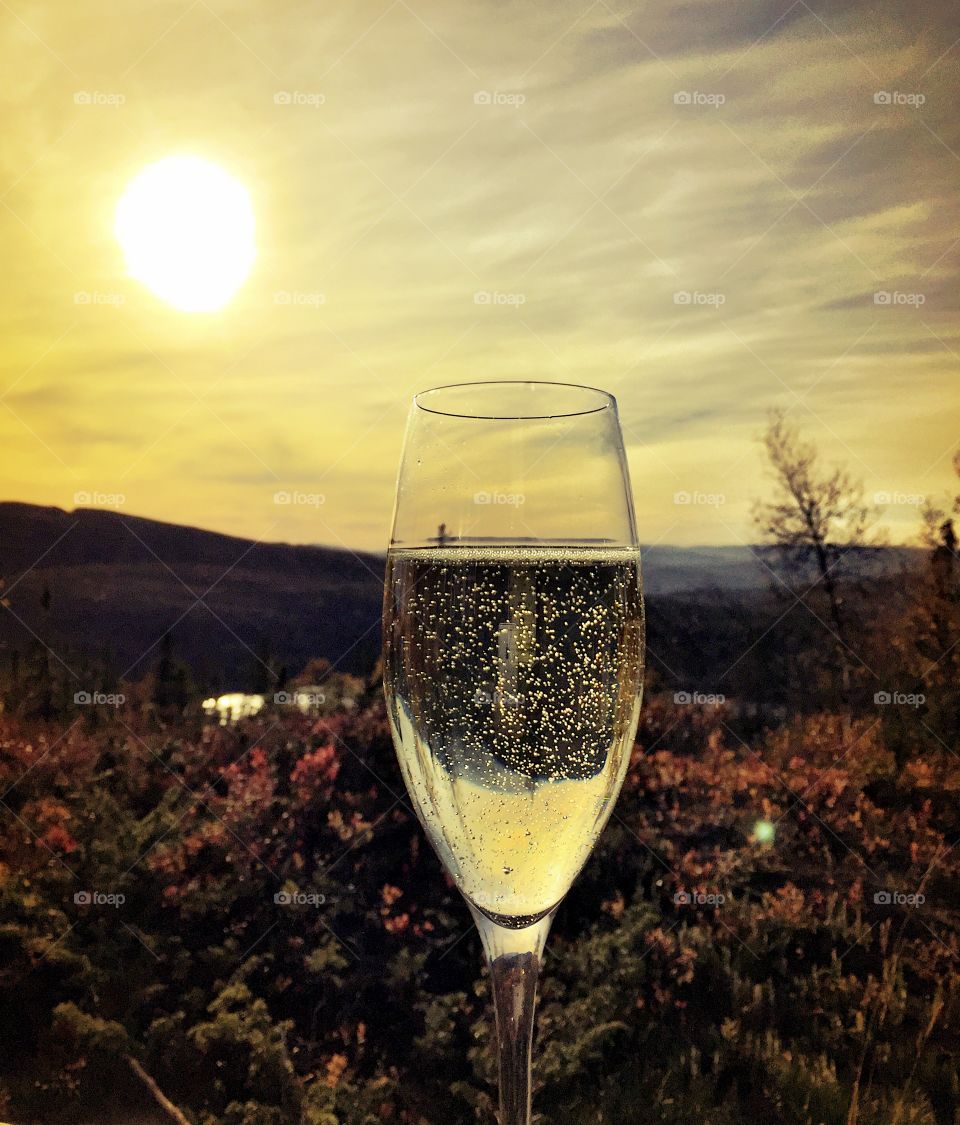 Sunset champagne . A toast to the beautiful mountain sunset that turns into gold
