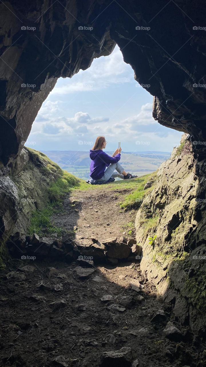 Let's go to. Hiking in the UK. Beautiful scenery, amazing view, good weather. A woman sits and takes pictures of the beautiful nature around...