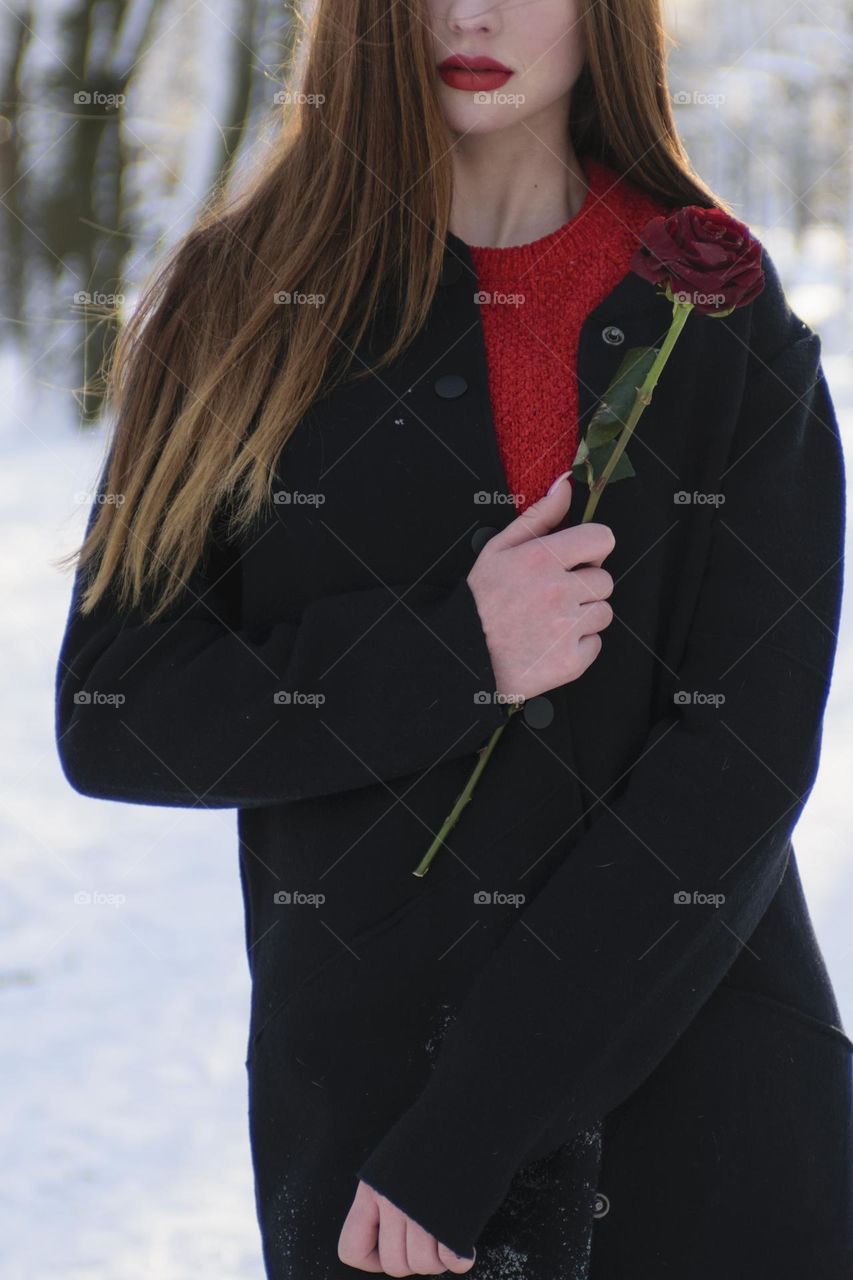 Girl with beautiful long hair in winter park park.