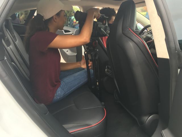 University of Central Florida Knightly news located in backseat of white Tesla.