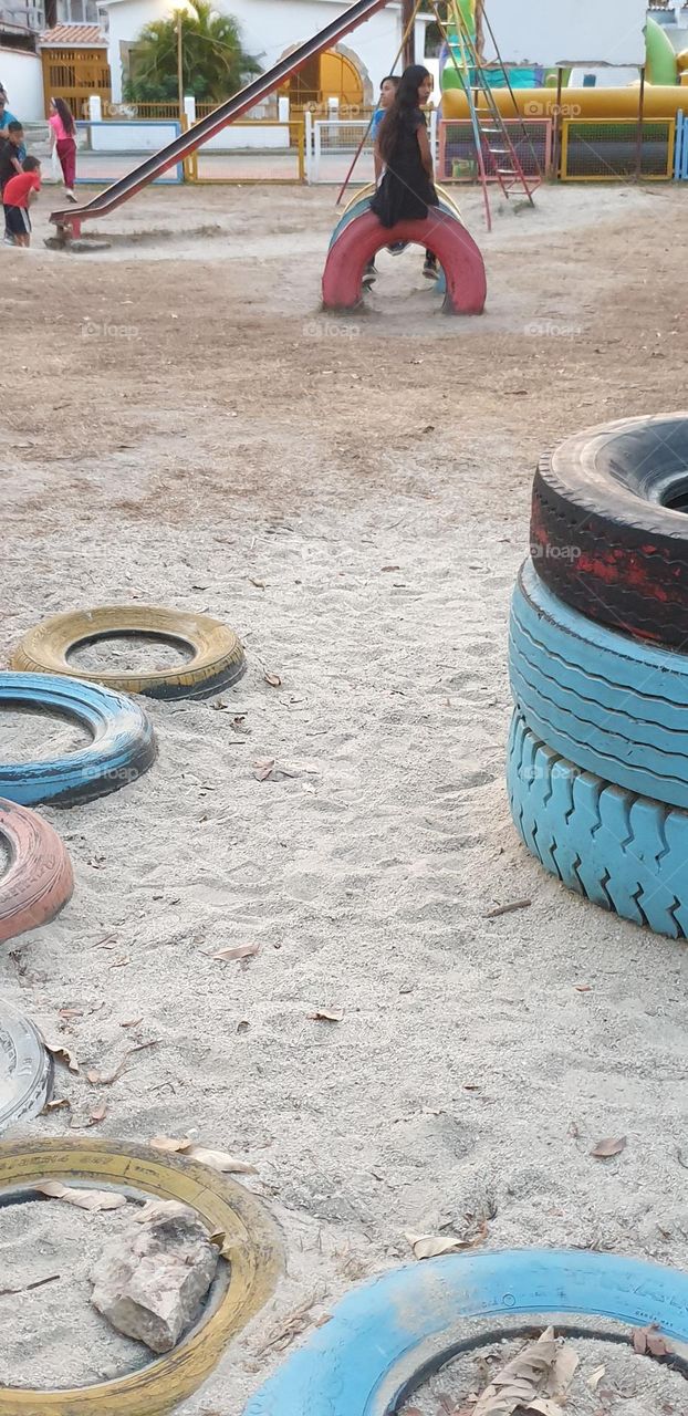 Playground, colored rubbers in the sand, circles, games for children.