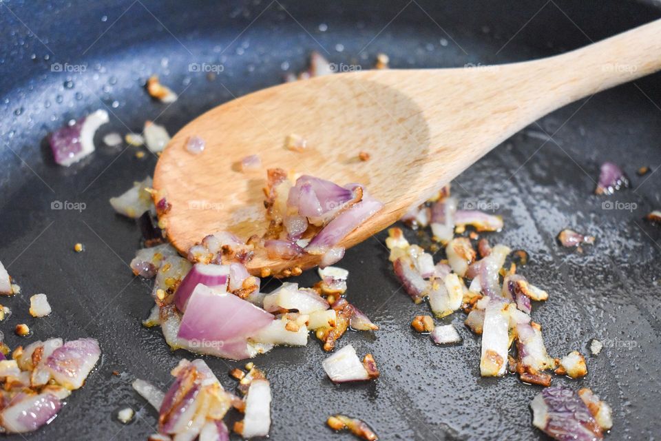 Homecooking cooking Frittata at home and adding and mixing ingredients and removing the Frittata from the pan for cutting and serving on a white plate with tomatoes. Healthy home cooking in kitchen. Breakfast and lunch food preparation.