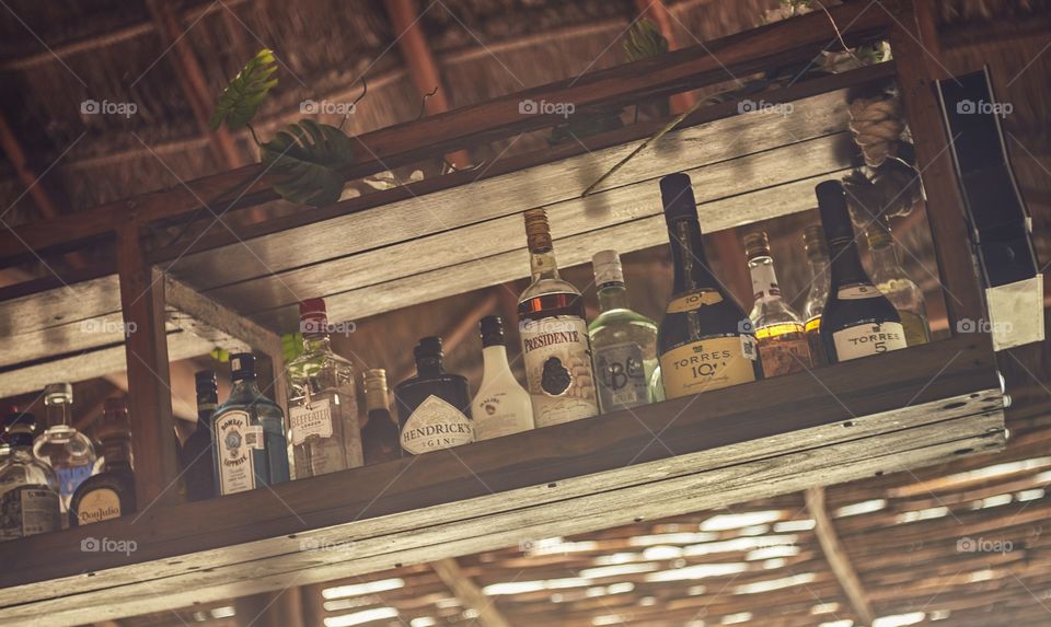 Shelf full of liquor bottles in a bar in Isla Mujeres, Mexico